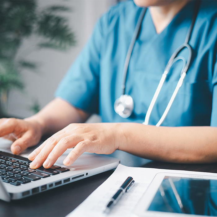A health programs student at her desk. A health programs student at her desk.