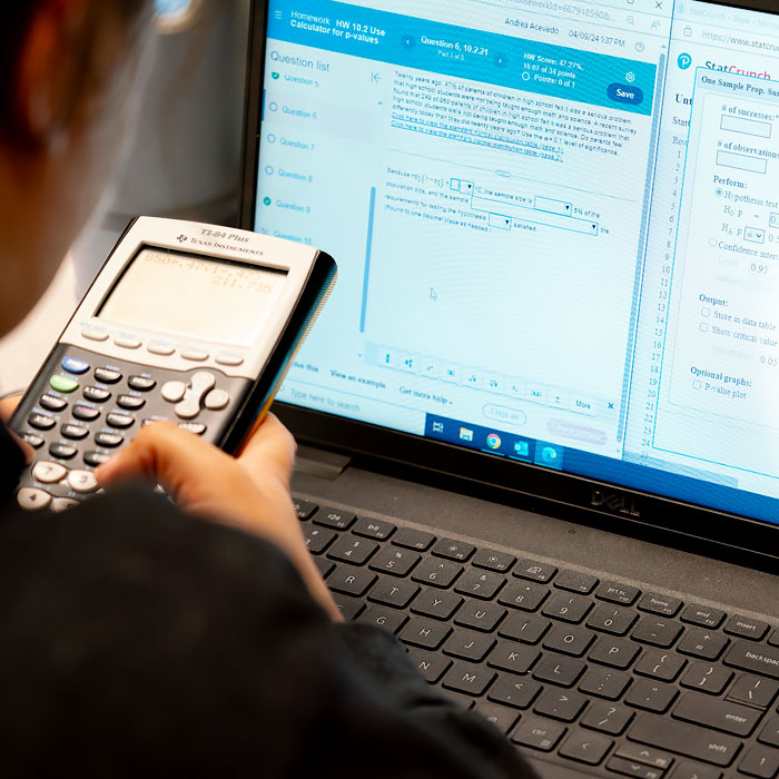 A student working with a scientific calculator.