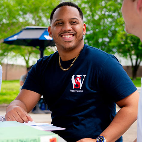 A Walters State student sits at an outdoor study area.