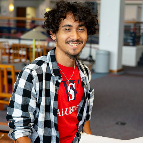 A Dual Enrollment alumni sits in the Walters State Library.