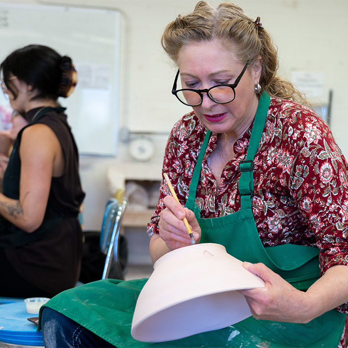 A student working on a pottery piece.