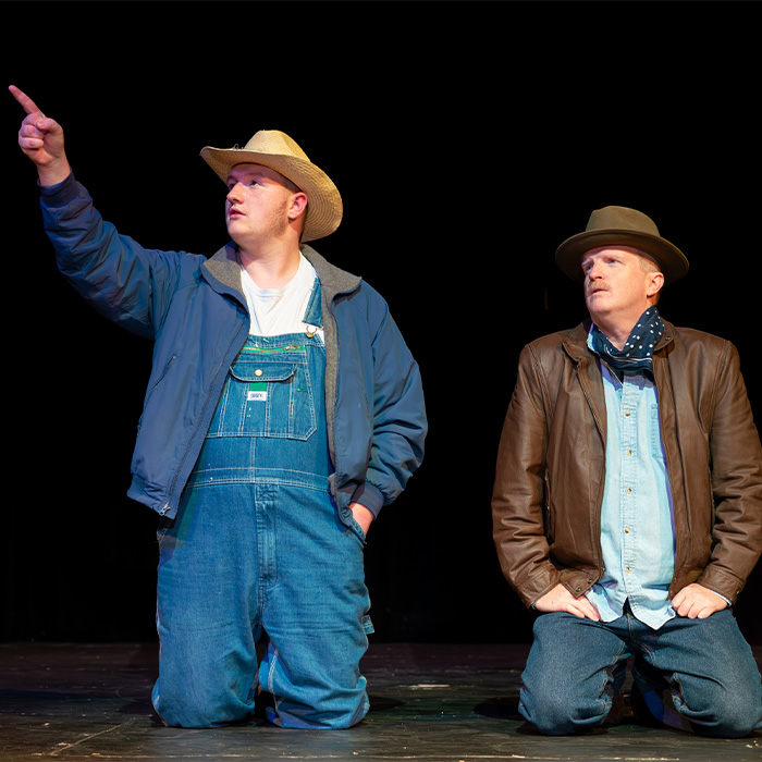 Actors on a stage performing of mice and men