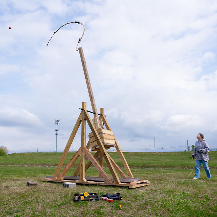 Student with trebuchet